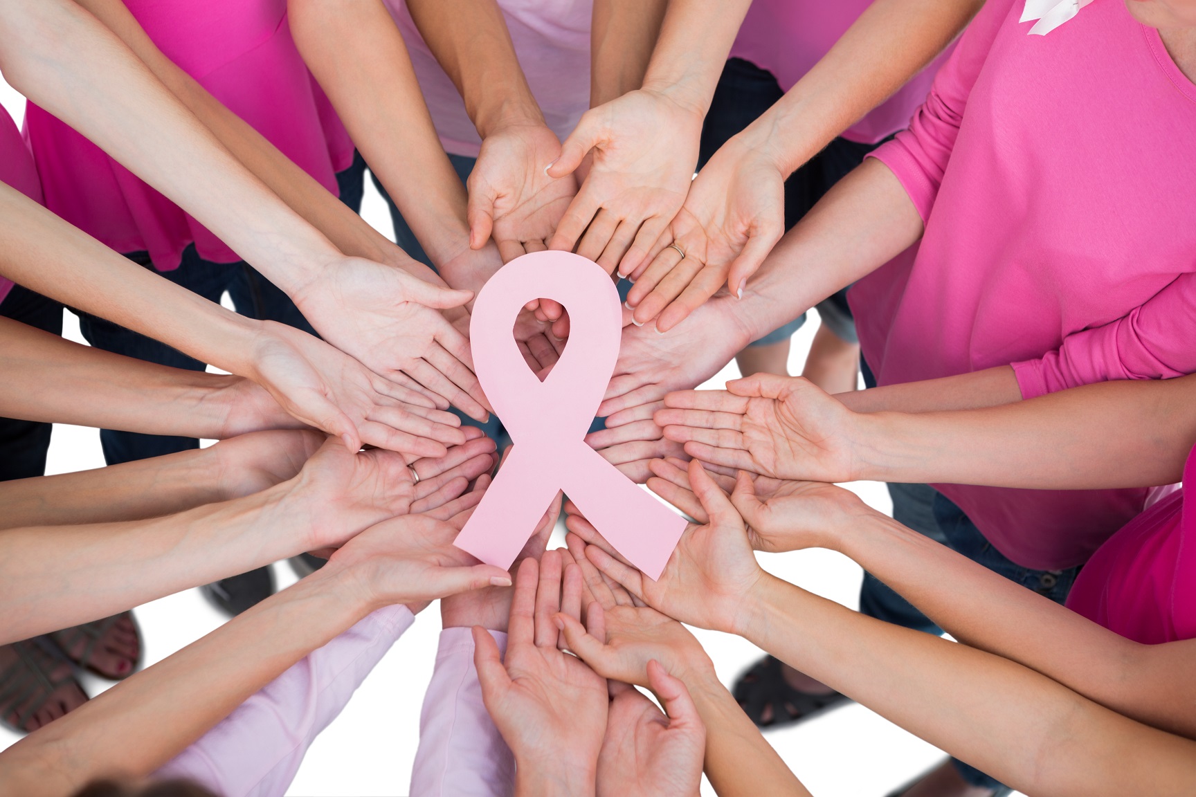 picture of hands joined in circle around the breast cancer symbol