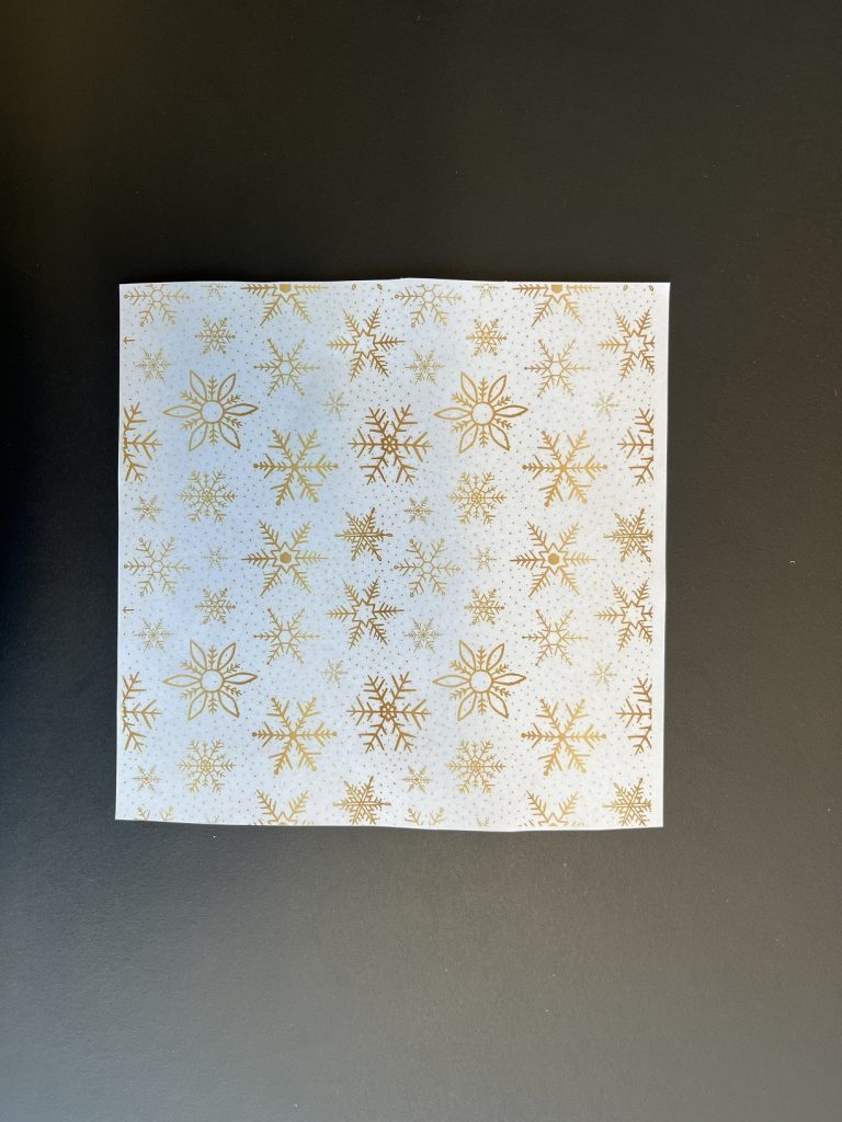 a piece of paper with golden snowflakes